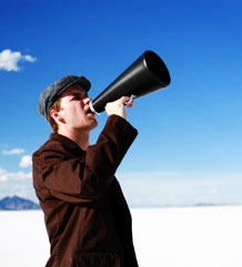 Image of a man yelling into a bullhorn.