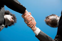 Image of an employee shaking hands with his employer.